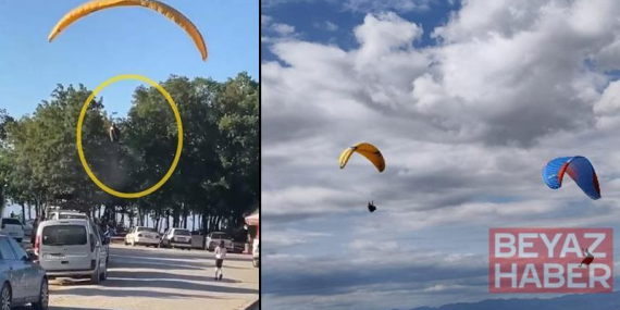 Paraşütçünün ağaca kontrollü inişi, çevredekileri endişelendirdi