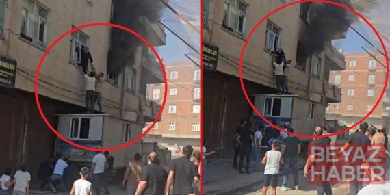 Yangında mahsur kalan kadını konteynerin üzerine çıkarak kurtardılar