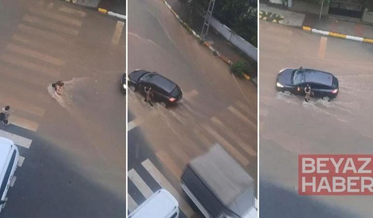Sultanbeyli’de yağmur suyunda sürüklenerek yere düşen çocuğa sürücü yardım etti
